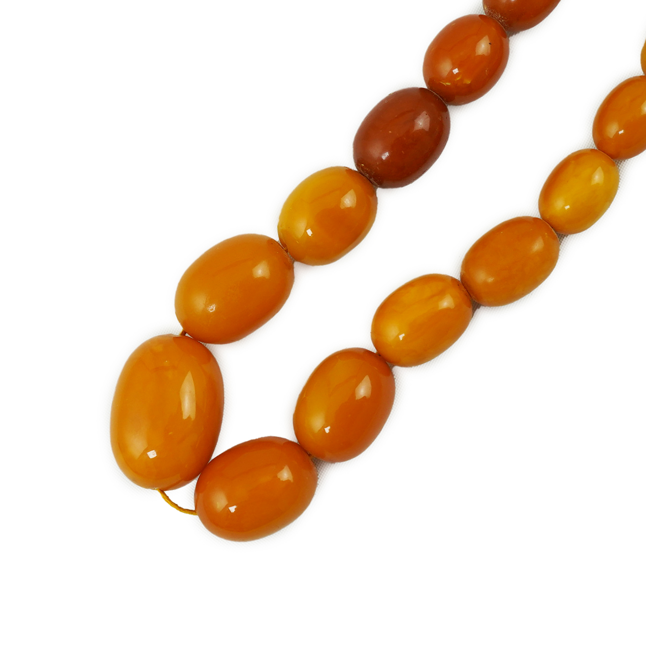 A single strand graduated oval amber bead necklace